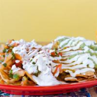 Loaded Nachos · Topped with melted cheese, beans, guacamole, pico de gallo and sour cream.