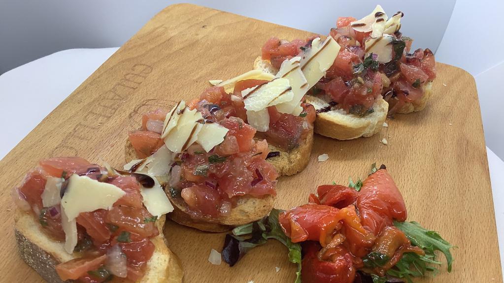 Bruschetta · Diced tomatoes, red onions, garlic, basil, olive oil, Served over crispy Seasoned Italian bread slices, drizzled with balsamic glaze, And shaved parmesan cheese.
