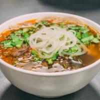 Bun Bo Hue · Spicey lemongrass beef noodle soup top with flank,shank,pork sausage and roll.