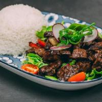 Bo Luc Lac · Wok tossed filet mignon with onions and peppers on a bed of arugula mix served with jasmine ...