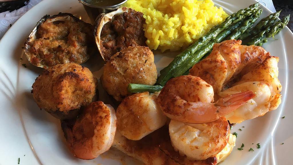 Seafood Combination · Broiled lobster tail, jumbo shrimp, sea scallops, clams casino, and lump crabmeat imperial stuffed mushrooms and broiled flounder filet. Served with small chopped salad, accompanied by sautéed seasonal vegetables and tasty Parmesan risotto.