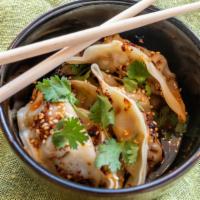Pork Gyoza · Six steamed pork gyoza served with a soy dipping sauce or in  spicy chili sauce.