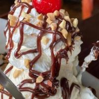 Brownie Sunday · Big brownie, vanilla ice cream, hot fudge, whipped cream, crushed nuts and a cherry on top