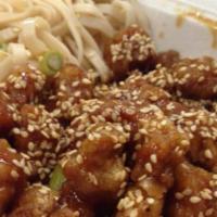 Sesame Chicken · Crunchy pieces of chicken tossed with sticky honey glaze topped with sesame.
