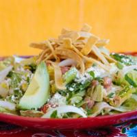 Quetzally Salad · Queso fresco, avocado, BBQ chipotle dressing, cilantro, corn, romaine lettuce and tortilla c...