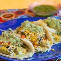 Veggie Tacos Tex Mex · Three corn tortillas with lettuce, cheese and guacamole.