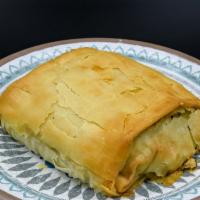 Spanakopita · Fresh spinach, feta, dill, and scallions wrapped in a filo crust. Vegetarian.