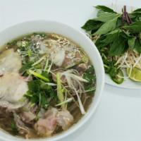 P3-Phở Đặc Biệt · Sliced of rare eye round steak, well-done brisket, flank, tendon, and beef balls noodle soup.