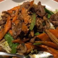 Garlic Stir-Fry · Stir-fried with mushrooms, carrots, baby corn and snow peas, topped with a crispy garlic and...