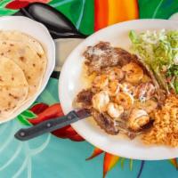 Cancun House Rib-Eye (12.02 Oz.) · Rib-eye steak and six shrimp with pico de gallo and cheese. Served with rice, guacamole sala...
