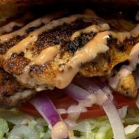 Blackened Chicken Burger · The blackened chicken burger is our seasoned grilled chicken, topped with lettuce, tomato, o...