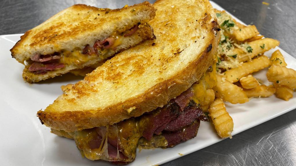 Spicy Pastrami Griller · pastrami, provolone, spicy Kenai cheese loaded on our stone baked white bread.  Comes with garlic fries.