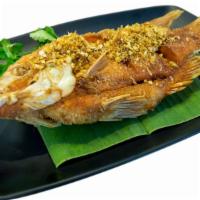 Fried Fish · Fresh fried tender flaked fish seasoned in a Jamaican style mix of herbs and spices.