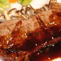 Beef Teriyaki With Rice · Broiled to perfection, then smothered in our own special teriyaki sauce. Served with broccol...