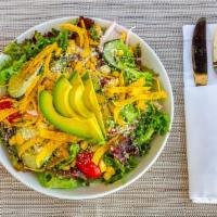 Grilled Corn Salad · Avocado, grilled corn, mixed greens, cotija cheese, red onions, tomatoes, cucumbers, and tor...