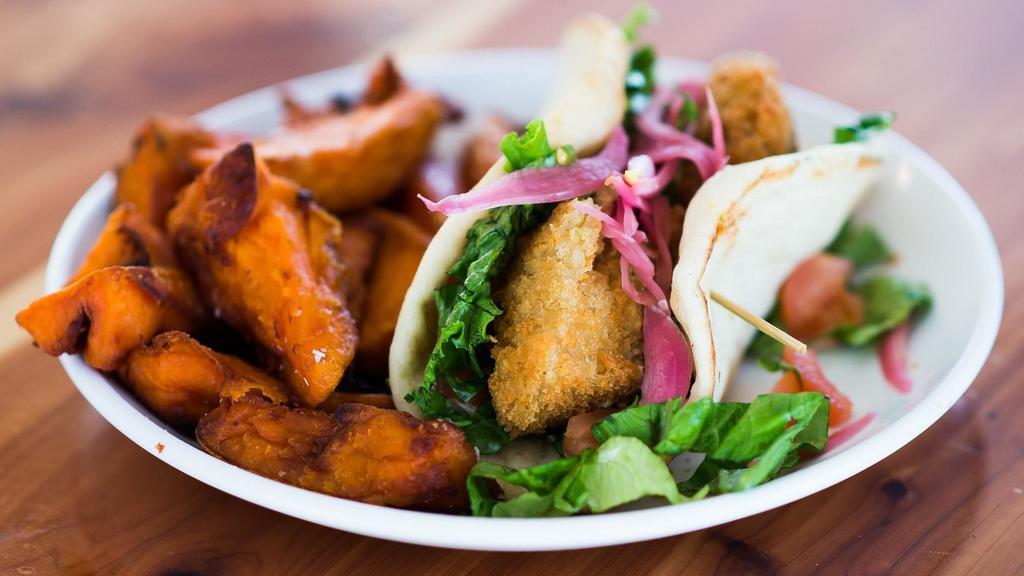 Falafel On Pita (Dinner) · Fried falafel with pickled red onions, lettuce, cucumbers, tomatoes, and tzatziki sauce. Served with your choice of french fries, sweet potato wedges, or side salad.