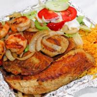 Grilled Tilapia · Two pieces. Served with two choice of sides rice and salad or rice and black beans.