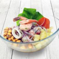 Ceviche Mixto · Fresh fish and seafood marinated in fresh lime juice, mixed with 