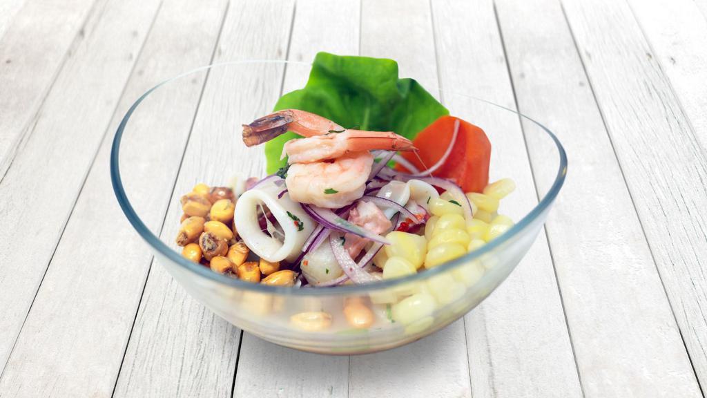 Ceviche Mixto · Fresh fish and seafood marinated in fresh lime juice, mixed with 