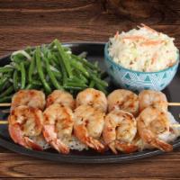 Camarones Al Grill · Marinated Gulf shrimp skewered and charbroiled to order. Served with choice of two sides.