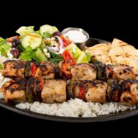 World Famous Souvlaki · Medallions of chicken tenderloin, peppers, and onions on skewer, served with “Greek Salad”, ...
