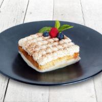 Tres Leches · Decadent sponge cake soaked in milk and cream, topped with sweet cream and cinnamon.