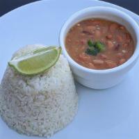 White Rice & Beans · Steamed white rice, along with beans simmered in sofrito and butternut squash. Your choice o...