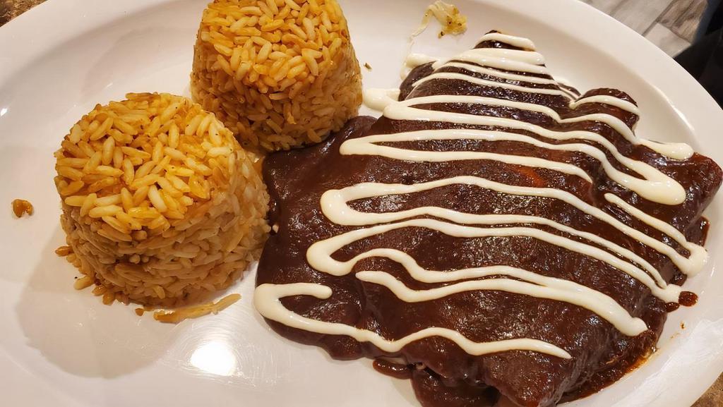 Enchiladas · Three soft corn tortillas topped with cheese, sour cream and the sauce of your choice of mole or tomatillo. Served with rice and beans.
