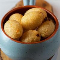 Bolitas De Yuca · Yuca fritters stuffed with queso fresco served with guava 
dipping sauce. Six per order.