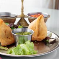 Meat Samosa (2 Pieces) · Crispy turnovers stuffed with ground lamb, spiced potatoes and peas.