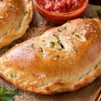 Meat Lovers Calzone · Pepperoni, Canadian bacon, salami, Italian sausage, mozzarella, Parmesan and ricotta cheeses.