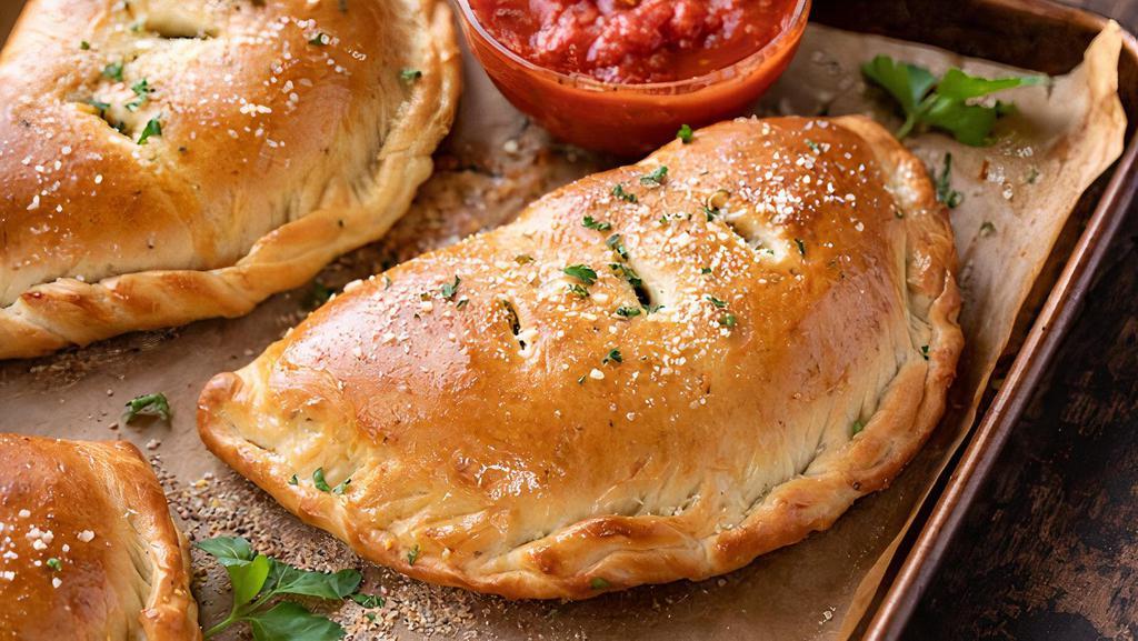Meat Lovers Calzone · Pepperoni, Canadian bacon, salami, Italian sausage, mozzarella, Parmesan and ricotta cheeses.