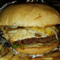 Signature Burger · 1/2 lb. Fried egg, topped with three bacon strips, grilled jalapeño peppers and covered with...