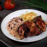 Jerk Chicken Dinner · Jerk chicken made with our signature spices and sauce, on rice & peas and cabbage.