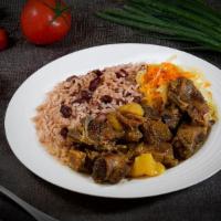 Curried Goat Dinnner · Goat morsels simmered in our special curry blend, on rice & peas and cabbage.