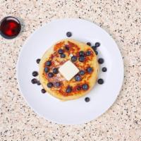 Blueberry Pancakes · Three fluffy blueberry pancakes with maple syrup and butter.