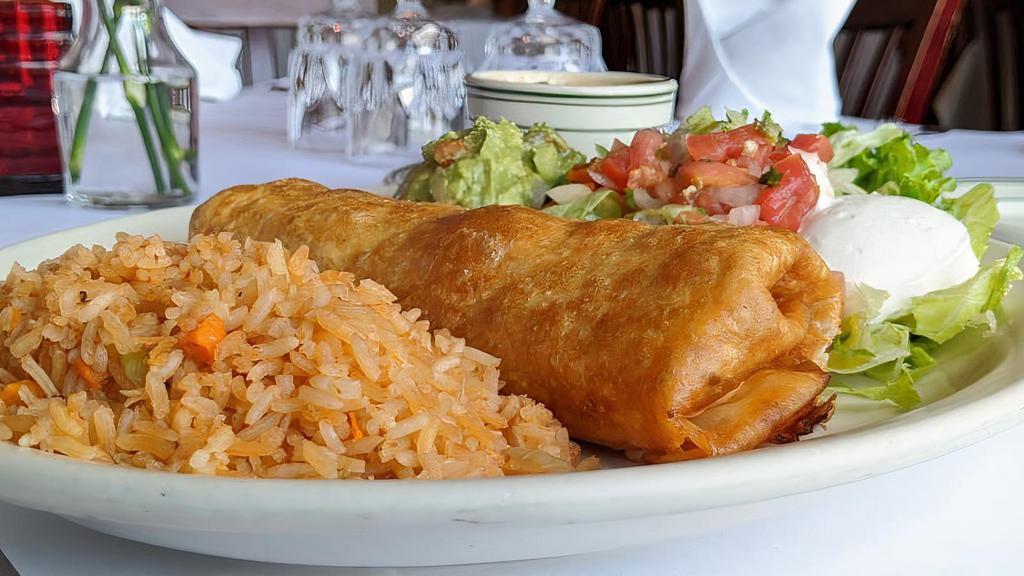 Chimichanga · Flour tortilla stuffed with shredded Beef or shredded Chicken quick-fried served with guacamole, sour cream, and pico de gallo.