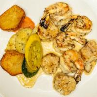 Spidini Di Capesante E Gamberette · Grilled shrimp and scallops on skewers, finished with lemon citrus beurre Blanc.