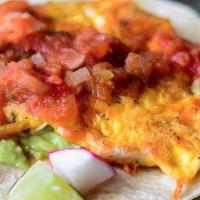 Breakfast Taco · Scrambled eggs, longhorn cheese, avocado crema, and roasted salsa on a flour tortilla