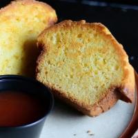 Corn Muffin · fresh baked corn muffin split in half and griddled with butter. Served with house made guava...
