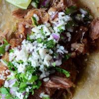 Carnitas Pork Taco · Confit pork shoulder, salsa verde, cilantro, onion, queso fresco, corn tortilla