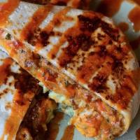El Cruncho · Dallas spicy beef, chili queso, longhorn cheese, avocado crema, lettuce and tomato with a cr...