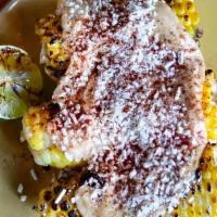 Grilled Corn · Three half ears of corn on the cob grilled and topped with a garlic-lime aioli and cotija ch...