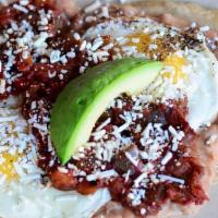 Huevos Rancheros · Two house corn tortillas topped with refried beans, ranchero sauce, two fried eggs, fresh av...