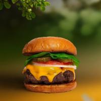 Cheese Bliss Vegan Burger · Seasoned plant-based patty topped with melted vegan cheese, lettuce, tomato, onion, and pick...