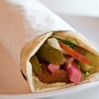 Beef Shawarma · Tender beef marinated overnight, slow cooked on vertical rotisseries, served with tomato, pi...