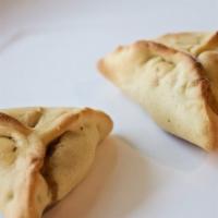 Spinach Pie · Dough triangle stuffed with spinach, chopped onion, dill and feta cheese, then baked.