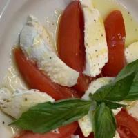 Caprese Salad · Fresh mozzarella and plum tomatoes topped with basil and olive oil.