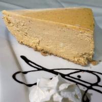 Pumpkin Cheesecake · A creamy pumpkin cheesecake sitting on a graham cracker crust