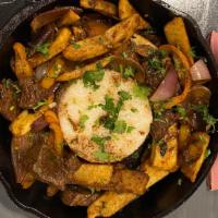 Lomo Saltado · A generous portion of beef, sautéed with tomatoes, French fries, red onions, peppers and cil...